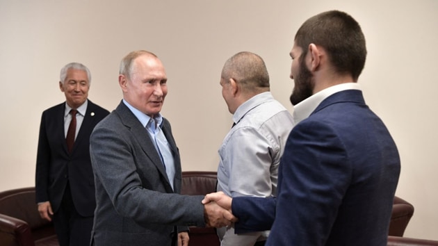 Russian President Vladimir Putin shakes hand with Khabib Nurmagomedov.(@EmbassyofRussia)