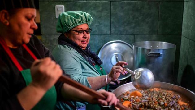 Women serve food at the soup kitchen. The government has refused so far. “There are situations of poverty, but that does not mean that there is hunger,” Culture Minister Pablo Avelluto said. The six women who distribute food from Avia’s kitchen receive a supplementary salary from the state, equivalent to half the minimum wage, 7,500 pesos ($110 currently). It’s hardly enough to get by. (Ronaldo Schemidt / AFP)