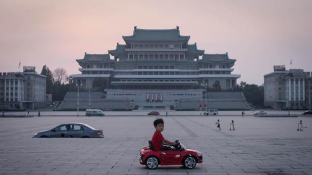 A child drives a miniature electric toy car across Kim Il Sung square in Pyongyang, North Korea. The country marked marking the 71st anniversary of its foundation, with a public holiday. (Ed Jones / AFP) A child drives a miniature electric toy car across Kim Il Sung square in Pyongyang, North Korea. The country marked marking the 71st anniversary of its foundation, with a public holiday. (Ed Jones / AFP)
