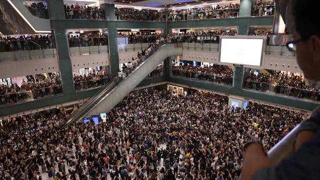 People gather at a shopping mall in the Shatin area of Hong Kong to sing a recently penned protest song titled ‘Glory to Hong Kong’ which has been gaining popularity in the city as an anthem. (Nicolas Asfouri / AFP) People gather at a shopping mall in the Shatin area of Hong Kong to sing a recently penned protest song titled ‘Glory to Hong Kong’ which has been gaining popularity in the city as an anthem. (Nicolas Asfouri / AFP)