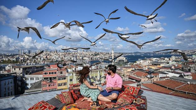 A couple sit on the terrace of a cafe in Istanbul as seagulls fly over them in Turkey. (Ozan Kose / AFP) A couple sit on the terrace of a cafe in Istanbul as seagulls fly over them in Turkey. (Ozan Kose / AFP)