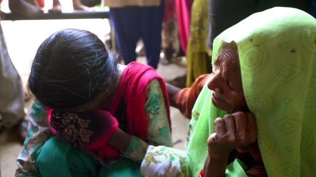 Rani (L), daughter of the deceased, grieves the death of her father who was attacked by a mob while passing through Asalatpur Jarai on a motorbike carrying his sick nephew Ravi to a hospital. In the video, the mob first beats the two men, Raju and Ramavtar with their hands, slapping and punching them till they fall down. The beating continues, egged on by cries of “maro, maro (beat them)” resonating through the crowd. (Amal KS / HT Photo) Rani (L), daughter of the deceased, grieves the death of her father who was attacked by a mob while passing through Asalatpur Jarai on a motorbike carrying his sick nephew Ravi to a hospital. In the video, the mob first beats the two men, Raju and Ramavtar with their hands, slapping and punching them till they fall down. The beating continues, egged on by cries of “maro, maro (beat them)” resonating through the crowd. (Amal KS / HT Photo)