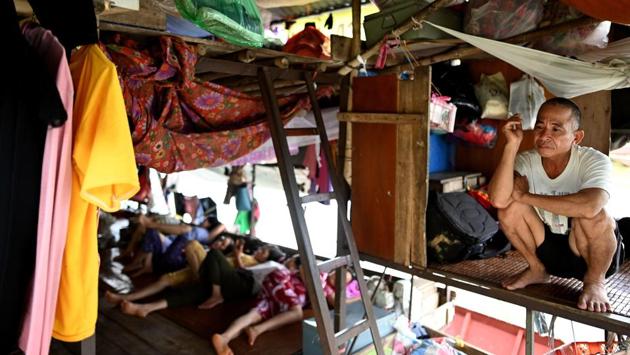 Han Van Hoa, living for the past 10 years in a floating guesthouse with his wife, smokes a cigarette as others take a nap after a day's work. “It’s a big home where we share our troubles with each other. If I’m in a pinch I can easily borrow money,” said 54-year-old market seller Han Van Hoa. (Manan Vatsyayana / AFP) Han Van Hoa, living for the past 10 years in a floating guesthouse with his wife, smokes a cigarette as others take a nap after a day's work. “It’s a big home where we share our troubles with each other. If I’m in a pinch I can easily borrow money,” said 54-year-old market seller Han Van Hoa. (Manan Vatsyayana / AFP)