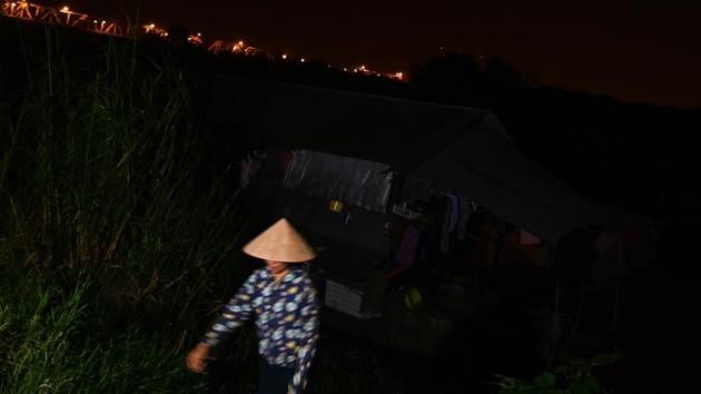 A migrant worker leaves for work in the early hours of the morning. Like the rest of his temporary neighbours, Han Van Hoa rises before dawn to buy his fruit wholesale before heading to a Hanoi market. While the city has transformed from a quiet backwater to a fast-growing commercial centre, he says people like him have remained rooted to the bottom of the social pyramid. “Hanoi has developed… But we haven’t.” (Manan Vatsyayana / AFP) A migrant worker leaves for work in the early hours of the morning. Like the rest of his temporary neighbours, Han Van Hoa rises before dawn to buy his fruit wholesale before heading to a Hanoi market. While the city has transformed from a quiet backwater to a fast-growing commercial centre, he says people like him have remained rooted to the bottom of the social pyramid. “Hanoi has developed… But we haven’t.” (Manan Vatsyayana / AFP)