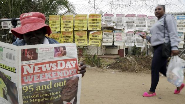 An ice cream vendor reads a newspaper on a street in Harare. The chaotic, often violent confiscations triggered a collapse of the once productive agricultural sector and began a downward economic spiral. Further mismanagement brought about hyperinflation reaching more than 1 billion percent in 2009, which was only halted when the country abandoned its currency for the U.S. dollar. (Themba Hadebe / AP) 