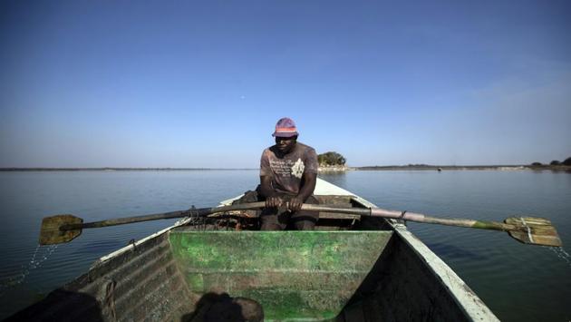 A fisherman rows his boat after casting his nets for the night, in Lake Chivero, west of the Harare. The city once enjoyed a reputation for being a city with lights on all night. But with widespread power cuts lasting 19 hours per day, residents find themselves living like rural famers, getting up at dawn and going to bed at dark. (Ben Curtis / AP) 