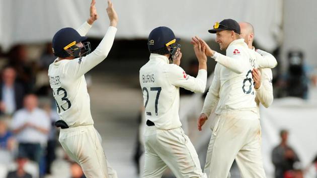 England's Joe Root celebrates with teammates after taking a catch to dismiss Australia's Josh Hazlewood.(Action Images via Reuters)