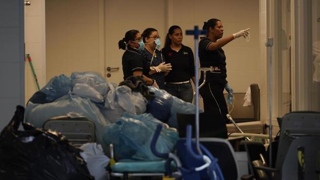 Hospital employees work next to medical equipments at the Badim Hospital, where a fire left at least 11 people dead, in Rio de Janeiro, Brazil on Friday. The fire raced through the hospital forcing staff to wheel patients into the streets on beds or in wheelchairs.(AP Photo) Hospital employees work next to medical equipments at the Badim Hospital, where a fire left at least 11 people dead, in Rio de Janeiro, Brazil on Friday. The fire raced through the hospital forcing staff to wheel patients into the streets on beds or in wheelchairs.(AP Photo)