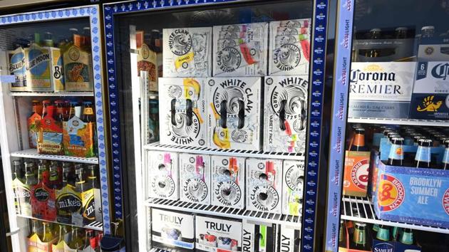 Cartons of White Claw, a flavoured alcoholic fizz in a can are on display at the Round The Clock Deli September 11, 2019 in New York City. - Health-conscious American millennials have found their drink of choice: alcoholic carbonated water that is lower in calories and carbs than beer and wine. A hard seltzer craze is sweeping the United States as Generation Y and Generation Z pursue healthier lifestyles, influenced by viral trends on Instagram and YouTube. (Photo by TIMOTHY A. CLARY / AFP)(AFP)