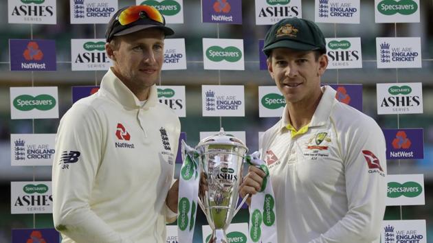 England's Joe Root, left, and Australia's Tim Paine hold the trophy during the presentation ceremony(AP)