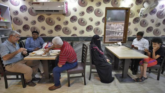 Patrons dine at Ya Mal Alsham. Asked what makes his food such a hit, Abdullah says, “Syrian food is standard Arabian food, if cooked right it will be liked anywhere in the world.” Omar, 30, and Maher, 26, Syrian students on a scholarship, seem to concur saying they frequently visit the restaurant. “This place is home for Syrians in Delhi like me, where we bond over food,” says Maher. (Burhaan Kinu / HT Photo)
