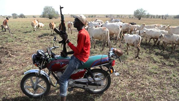 A Turkana warrior holds a gun as he protects cattle. Such raids can be a disaster for a community. There’s little money here. All serious transactions are done with livestock. Warrior Matthew Logel Matteze told Tomasevic he had to pay his wife’s family 16 cows and 60 goats to marry her. Kenya and South Sudan have set up a joint commission to try to agree on the disputed border. (Goran Tomasevic / REUTERS) A Turkana warrior holds a gun as he protects cattle. Such raids can be a disaster for a community. There’s little money here. All serious transactions are done with livestock. Warrior Matthew Logel Matteze told Tomasevic he had to pay his wife’s family 16 cows and 60 goats to marry her. Kenya and South Sudan have set up a joint commission to try to agree on the disputed border. (Goran Tomasevic / REUTERS)