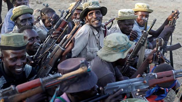 Turkana warriors react after finding out that Nyangatom warriors are around their settlement. When danger looms, locals say the police are usually far away and neighbours are the only ones they can turn to. (Goran Tomasevic / REUTERS) Turkana warriors react after finding out that Nyangatom warriors are around their settlement. When danger looms, locals say the police are usually far away and neighbours are the only ones they can turn to. (Goran Tomasevic / REUTERS)