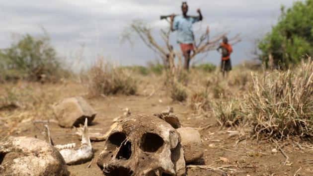 A Turkana warrior passes by a skull of a Nyangatom warrior who, according to Turkana warriors, was killed during an attack on Turkana people to take their cattle. Reuters photographer Goran Tomasevic saw seven or eight places scattered with skulls or bones with shredded clothing during the three weeks he spent in the region. There are a lot of wild animals so bodies left outside don’t stay intact for long. (Goran Tomasevic / REUTERS) A Turkana warrior passes by a skull of a Nyangatom warrior who, according to Turkana warriors, was killed during an attack on Turkana people to take their cattle. Reuters photographer Goran Tomasevic saw seven or eight places scattered with skulls or bones with shredded clothing during the three weeks he spent in the region. There are a lot of wild animals so bodies left outside don’t stay intact for long. (Goran Tomasevic / REUTERS)