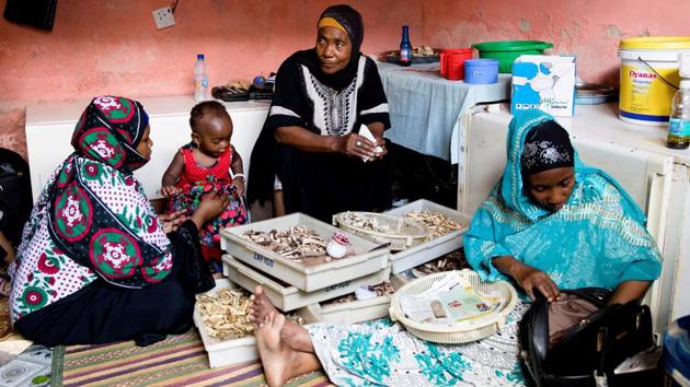 Traditional healer Bi Mwanahija Mzee (C), 56, folds root medicine in a piece of paper to give to a mother who complains of her child's constipation. “People come here because I actually help them. I met many patients that went to hospital first and got no help or the medicine didn't work,” said Mwanahija Mzee. “This is my job six days a week for more than 20 years so I do better, know more than them. Patients that come to me don't die.” (Nicky Woo / REUTERS) Traditional healer Bi Mwanahija Mzee (C), 56, folds root medicine in a piece of paper to give to a mother who complains of her child's constipation. “People come here because I actually help them. I met many patients that went to hospital first and got no help or the medicine didn't work,” said Mwanahija Mzee. “This is my job six days a week for more than 20 years so I do better, know more than them. Patients that come to me don't die.” (Nicky Woo / REUTERS)