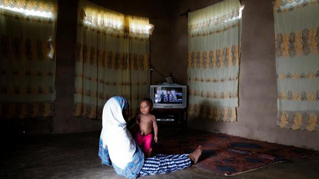 Nadra holds her eight-month-old child Muhammad Ali, in their living room in Zanzibar City. Nadra took Muhammad to Bi Mwanahija Mzee who is already registered, to seek relief for her child suffering from an umbilical hernia. She initially took him to hospital, but is scared that if she brings the child to hospital for surgery he will die. (Nicky Woo / REUTERS) Nadra holds her eight-month-old child Muhammad Ali, in their living room in Zanzibar City. Nadra took Muhammad to Bi Mwanahija Mzee who is already registered, to seek relief for her child suffering from an umbilical hernia. She initially took him to hospital, but is scared that if she brings the child to hospital for surgery he will die. (Nicky Woo / REUTERS)