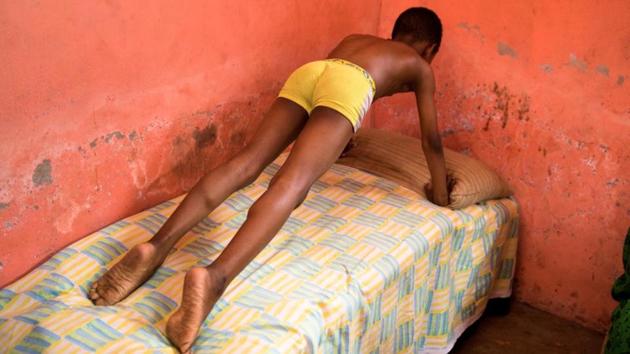 Murtazha Hamis, 11, brought in after suffering a stroke resulting in partial paralysis, does push-ups at Mwanahija Mzee's clinic.She uses a mix of massages, medicines from roots, herbs and leaves and Quranic verses, which may be written on a plate in red food colouring. The plate is then rinsed, and the water ingested as part of the medicinal regimen. (Nicky Woo / REUTERS) Murtazha Hamis, 11, brought in after suffering a stroke resulting in partial paralysis, does push-ups at Mwanahija Mzee's clinic.She uses a mix of massages, medicines from roots, herbs and leaves and Quranic verses, which may be written on a plate in red food colouring. The plate is then rinsed, and the water ingested as part of the medicinal regimen. (Nicky Woo / REUTERS)