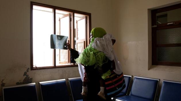 Fatma Hamad holds her two-year-old daughter, Khadija, while examining her x-rays at Mnazi Mmoja government hospital in Zanzibar City. Hamad took her daughter to hospital after one of the toddler's legs became paralysed during a high fever. Unable to find the problem through X-rays, the hospital recommended she seek out a traditional healer. (Nicky Woo / REUTERS) Fatma Hamad holds her two-year-old daughter, Khadija, while examining her x-rays at Mnazi Mmoja government hospital in Zanzibar City. Hamad took her daughter to hospital after one of the toddler's legs became paralysed during a high fever. Unable to find the problem through X-rays, the hospital recommended she seek out a traditional healer. (Nicky Woo / REUTERS)
