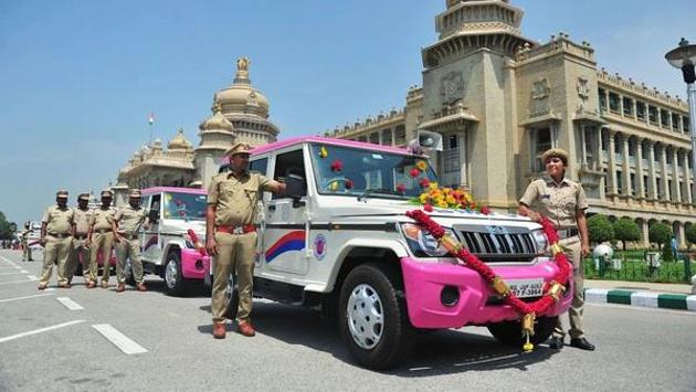 BMTC staff stand next to the pink Sarathi vehicles for women safety by Bangalore Metropolitan Transport Corporation.(PTI file photo)