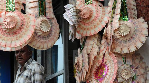 A vendor waits for customers at a stall with wedding garlands made from rupee notes at a market in Srinagar. In a status-conscious society famed for its hospitality, weddings have long served as a showcase for wealth and generosity, with guest lists regularly topping 1,500. “Families save for years or decades to splurge on weddings,” Bilal, who wanted to be identified only by his first name, told AFP. (Rouf Bhat / AFP)