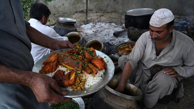Chefs put together a traditional wazwan platter for a traditional meal at a wedding. Even hiring cooks and butchers was a challenge because of the communication blackout, he said. “I had placed an order for a bed and given clothes for stitching to the tailor. Both the stores are closed and there is no way to contact them,” the 41-year-old told AFP. (Tauseef Mustafa / AFP)