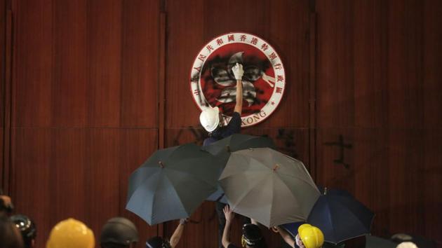 A protester defaces the Hong Kong emblem at the government headquarters on July 1. The day marked the next major demonstration, coinciding with the 22nd anniversary of Hong Kong’s handover from the UK to China. Demonstrators stormed the Legislative Council building, spraying graffiti, defacing Hong Kong’s emblem and displaying the colonial-era flag. (Vivek Prakash / AFP) A protester defaces the Hong Kong emblem at the government headquarters on July 1. The day marked the next major demonstration, coinciding with the 22nd anniversary of Hong Kong’s handover from the UK to China. Demonstrators stormed the Legislative Council building, spraying graffiti, defacing Hong Kong’s emblem and displaying the colonial-era flag. (Vivek Prakash / AFP)
