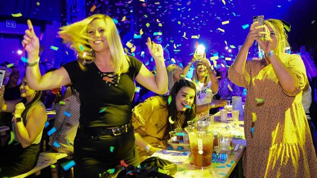 Customers celebrate at the 'Bongo's Bingo' event in Glasgow. Lyn Lappin, at 51 one of the oldest in attendance and usually a player at a more traditional venue, had ventured down with work colleagues. “I love it... It’s absolutely magic!” she said, drink in hand, joining in a raucous rendition of Neil Diamond’s “Sweet Caroline” during a break from the numbers. (Andy Buchanan / AFP) Customers celebrate at the 'Bongo's Bingo' event in Glasgow. Lyn Lappin, at 51 one of the oldest in attendance and usually a player at a more traditional venue, had ventured down with work colleagues. “I love it... It’s absolutely magic!” she said, drink in hand, joining in a raucous rendition of Neil Diamond’s “Sweet Caroline” during a break from the numbers. (Andy Buchanan / AFP)