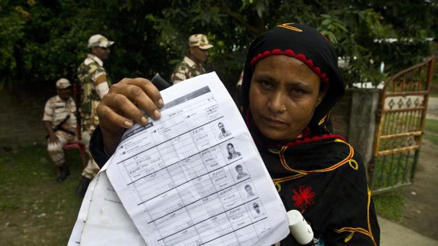 A woman displays a document that shows inclusion of her name in the final list of the National Register of Citizens (NRC) in Pabhokati village in Assam’s Morigaon district . (AP Photo) A woman displays a document that shows inclusion of her name in the final list of the National Register of Citizens (NRC) in Pabhokati village in Assam’s Morigaon district . (AP Photo)