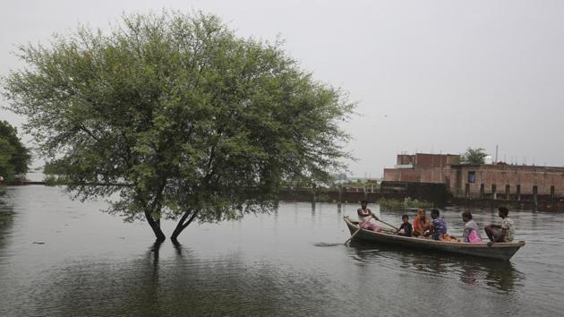 People move to safer areas on a boat through floodwaters in Prayagraj, Uttar Pradesh. Uttar Pradesh Chief Minister Yogi Adityanath on Wednesday directed officials in Allahabad and Varanasi districts to remain vigilant as the water levels in Ganga and Yamuna rivers neared the danger mark. Heavy rains over the past few days have caused the rivers to swell. (Rajesh Kumar Singh / AP) People move to safer areas on a boat through floodwaters in Prayagraj, Uttar Pradesh. Uttar Pradesh Chief Minister Yogi Adityanath on Wednesday directed officials in Allahabad and Varanasi districts to remain vigilant as the water levels in Ganga and Yamuna rivers neared the danger mark. Heavy rains over the past few days have caused the rivers to swell. (Rajesh Kumar Singh / AP)