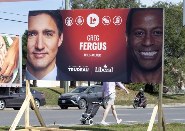 An election sign showing Liberal Leader Justin Trudeau, left, and Liberal Hull-Alymer candidate Greg Fergus (right), in Gatineau, Que. Thursday, Sept. 19, 2019. Fergus says he accepts the apology of Liberal leader Justin Trudeau after evidence emerged that the Liberal leader wore blackface at a Aladdin-themed end-of-year school dinner in 2001. (AP) An election sign showing Liberal Leader Justin Trudeau, left, and Liberal Hull-Alymer candidate Greg Fergus (right), in Gatineau, Que. Thursday, Sept. 19, 2019. Fergus says he accepts the apology of Liberal leader Justin Trudeau after evidence emerged that the Liberal leader wore blackface at a Aladdin-themed end-of-year school dinner in 2001. (AP)