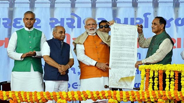 Prime Minister Narendra Modi and Chief Minister of Gujarat Vijay Rupani hold a poster at a public meeting along with Governor of Gujarat Acharya Dev Vrat, and Deputy Chief Minister of Gujarat, Nitinbhai Patel, at Kevadia, in Gujarat(ANI) Prime Minister Narendra Modi and Chief Minister of Gujarat Vijay Rupani hold a poster at a public meeting along with Governor of Gujarat Acharya Dev Vrat, and Deputy Chief Minister of Gujarat, Nitinbhai Patel, at Kevadia, in Gujarat(ANI)