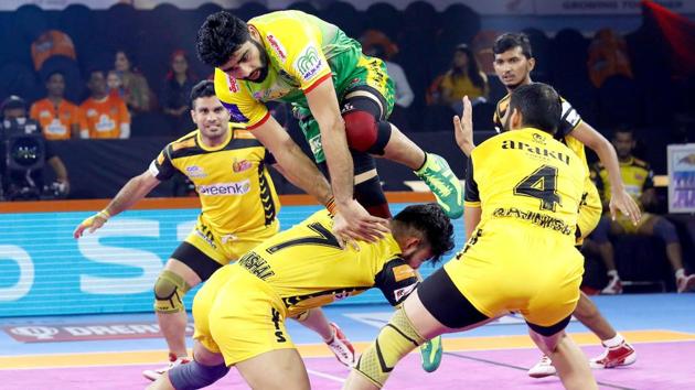 Pardeep Narwal tries to go for a raid against Telugu Titans.(PKL)