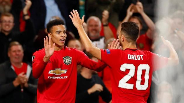 Manchester United's Mason Greenwood celebrates scoring their first goal with Diogo Dalot(Action Images via Reuters)