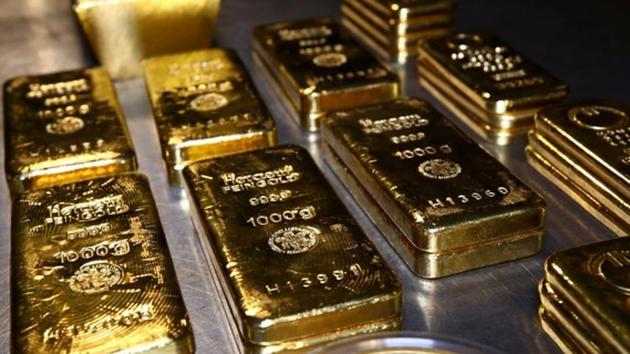 Gold up on soft dollar, set for first weekly gain in four - Hindustan Times