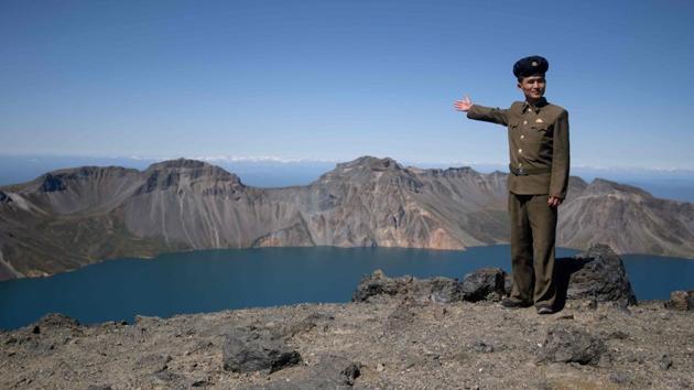 A North Korean student poses for a photo at the summit of Mount Paektu. The visiting troupes sing songs such as “We Will Go to Mount Paektu” and paddle joyously in Lake Chonji, its crater lake. “Everyone needs a spiritual pillar,” said Ri Yong Myong, 30, who is studying Korean literature at the elite Kim Il Sung University in Pyongyang after 10 years of military service. (Ed Jones / AFP) A North Korean student poses for a photo at the summit of Mount Paektu. The visiting troupes sing songs such as “We Will Go to Mount Paektu” and paddle joyously in Lake Chonji, its crater lake. “Everyone needs a spiritual pillar,” said Ri Yong Myong, 30, who is studying Korean literature at the elite Kim Il Sung University in Pyongyang after 10 years of military service. (Ed Jones / AFP)