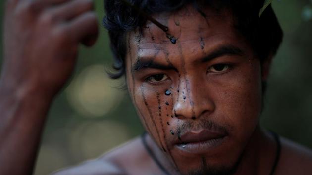 A Guajajara forest guardian paints his face whilst on Arariboia indigenous land. Fires in the Amazon, which often follow deforestation, are also up around 50% this year, according to government data, spurring global outcry at the response of Brazil’s President Jair Bolsonaro. The president has said the country’s indigenous reservations are too expansive. (Ueslei Marcelino / REUTERS) A Guajajara forest guardian paints his face whilst on Arariboia indigenous land. Fires in the Amazon, which often follow deforestation, are also up around 50% this year, according to government data, spurring global outcry at the response of Brazil’s President Jair Bolsonaro. The president has said the country’s indigenous reservations are too expansive. (Ueslei Marcelino / REUTERS)