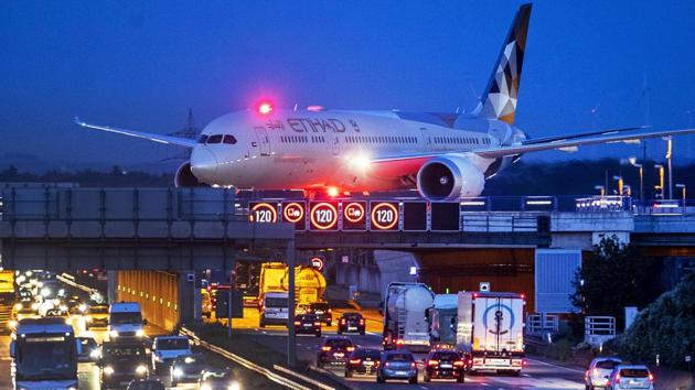 An aircraft crosses a bridge over a highway the airport in Frankfurt, Germany ahead of protests for the ‘Friday For Future’ movement against the increase of carbon dioxide emissions. (Michael Probst / AP) An aircraft crosses a bridge over a highway the airport in Frankfurt, Germany ahead of protests for the ‘Friday For Future’ movement against the increase of carbon dioxide emissions. (Michael Probst / AP)