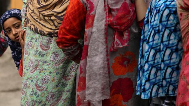 A Kashmiri girl looks at protesters after Friday prayers in Kashmir. The SC has asked J&K high court’s Juvenile Justice Committee to look into allegations that children were being held in detention by security forces after the revocation of J&K’s special status on August 5. (Reuters) A Kashmiri girl looks at protesters after Friday prayers in Kashmir. The SC has asked J&K high court’s Juvenile Justice Committee to look into allegations that children were being held in detention by security forces after the revocation of J&K’s special status on August 5. (Reuters)