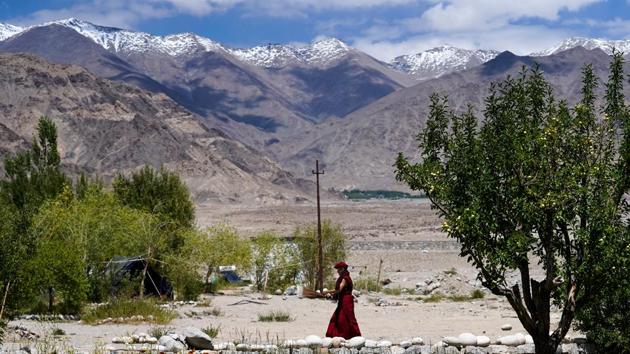 A Buddhist nun in the premises of a school with a broom to clean up along her way. The workshop was an extension aimed at the local community, of a reform that the austere lifestyles of the nuns have undergone. About a decade ago, Gyalwang Drukpa, the spiritual leader of the Drukpa school opened up this avenue of physical exercise, safety and empowerment for them. (Hemanshi Kamani / HT Photo) 