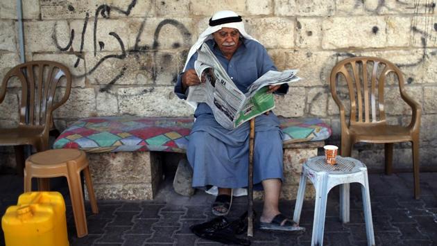 A Palestinian man reads a newspaper featuring news on the Israel’s parliamentary election, in the southern Gaza Strip. (Ibraheem Abu Mustafa / REUTERS) A Palestinian man reads a newspaper featuring news on the Israel’s parliamentary election, in the southern Gaza Strip. (Ibraheem Abu Mustafa / REUTERS)