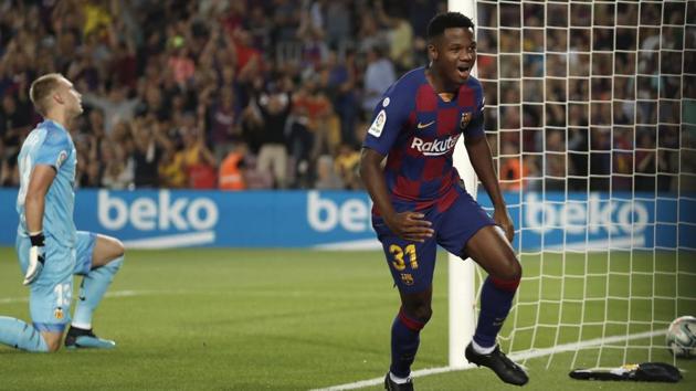 Ansu Fati celebrates after scoring the opening goal for Barcelona against Valencia. (AP) Ansu Fati celebrates after scoring the opening goal for Barcelona against Valencia. (AP)