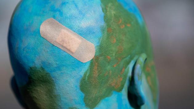 A protester is made up like a blessed globe during the “Fridays for Future” demonstration in Stuttgart, Germany during a protest for climate action, part of a global climate action day. (Sebastian Gollnow / dpa / AFP) A protester is made up like a blessed globe during the “Fridays for Future” demonstration in Stuttgart, Germany during a protest for climate action, part of a global climate action day. (Sebastian Gollnow / dpa / AFP)