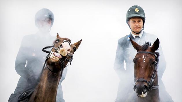 Members of the Cavalry honorary escort practice on the beach for Prinsjesdag in Scheveningen, Netherlands. The horses and riders involved are subjected to a final heavy test by exposing them to gunfire, cannon blows, music, smoke and possible public reactions. (Koen van Weel / ANP / AFP) Members of the Cavalry honorary escort practice on the beach for Prinsjesdag in Scheveningen, Netherlands. The horses and riders involved are subjected to a final heavy test by exposing them to gunfire, cannon blows, music, smoke and possible public reactions. (Koen van Weel / ANP / AFP)
