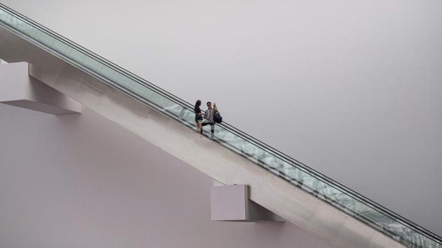 Visitors use an escalator at Marina Bay shopping mall in Singapore. (Mladen Antonov / AFP) Visitors use an escalator at Marina Bay shopping mall in Singapore. (Mladen Antonov / AFP)