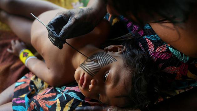 A Kayapo indigenous woman paints her daughter with a Kayapo traditional drawing in Bau village near Novo Progresso, Para state, Brazil. (Amanda Perobelli / REUTERS) A Kayapo indigenous woman paints her daughter with a Kayapo traditional drawing in Bau village near Novo Progresso, Para state, Brazil. (Amanda Perobelli / REUTERS)