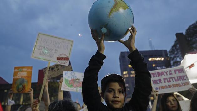 A boy holds up a small globe during a global protest on climate change in Sao Paulo, Brazil. Across the globe, hundreds of thousands of people took to the streets Friday to demand that leaders tackle climate change in the run-up to a UN summit. (Photo: AP) A boy holds up a small globe during a global protest on climate change in Sao Paulo, Brazil. Across the globe, hundreds of thousands of people took to the streets Friday to demand that leaders tackle climate change in the run-up to a UN summit. (Photo: AP)