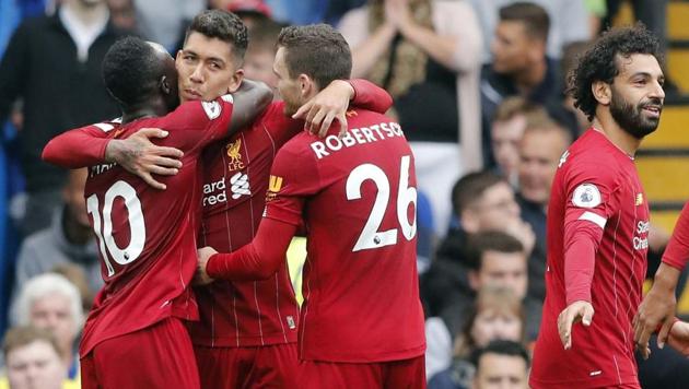 Liverpool's Roberto Firmino, center, celebrates with teammates Sadio Mane, left, and Andrew Robertson. (AP) Liverpool's Roberto Firmino, center, celebrates with teammates Sadio Mane, left, and Andrew Robertson. (AP)