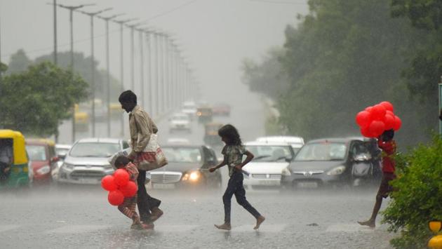 People cross the road during sudden rain, near Barakhamba, in New Delhi. (Amal KS / HT Photo) People cross the road during sudden rain, near Barakhamba, in New Delhi. (Amal KS / HT Photo)