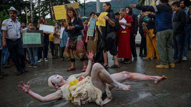 An environmental activist from Japan performs an act during a demonstration against governmental inaction towards climate breakdown and environmental pollution, in McLeodganj, Himachal Pradesh. (Lobsang Wangyal / AFP) An environmental activist from Japan performs an act during a demonstration against governmental inaction towards climate breakdown and environmental pollution, in McLeodganj, Himachal Pradesh. (Lobsang Wangyal / AFP)