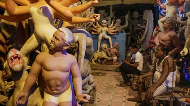 Artisans rest besides unfinished clay idols of Hindu goddess Durga at a studio in Kolkata, West Bengal. The idols are being made for worship venues ahead of Durga Puja festival that begins first week of October. (Bikas Das / AP) Artisans rest besides unfinished clay idols of Hindu goddess Durga at a studio in Kolkata, West Bengal. The idols are being made for worship venues ahead of Durga Puja festival that begins first week of October. (Bikas Das / AP)